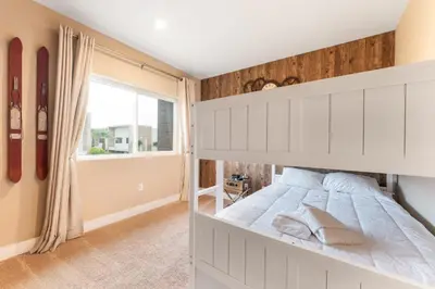 a bedroom with a white bed and a window at 7458 Magic Village 3suites 8guests jacuzzi 8 min Disney in Orlando