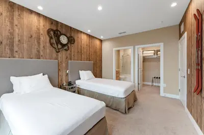 two beds in a room with wooden walls at 7589 Magic Village 8 guests 4 suites BBQ near 192 Disney in Orlando