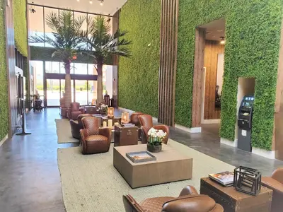 a lobby with couches and chairs and plants at 7589 Magic Village 8 guests 4 suites BBQ near 192 Disney in Orlando