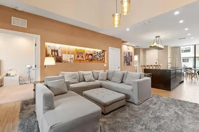 a living room with a couch and a dining room at 3045 Magic Village8 guests 4 suites BBQ 8 min Disney in Orlando