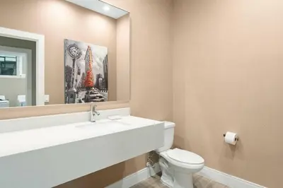 a bathroom with a sink and a toilet and a mirror at 3045 Magic Village8 guests 4 suites BBQ 8 min Disney in Orlando