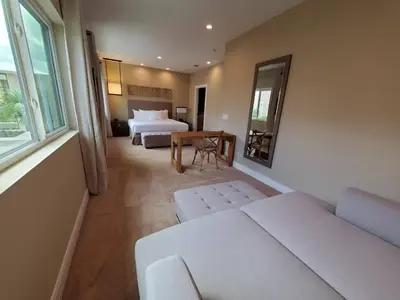 a hotel room with a bed and a couch and a table at 3045 Magic Village8 guests 4 suites BBQ 8 min Disney in Orlando