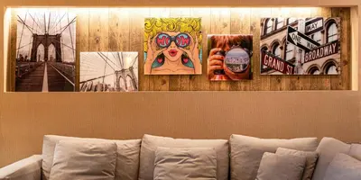 four pictures hanging on a wall above a couch at 3045 Magic Village8 guests 4 suites BBQ 8 min Disney in Orlando