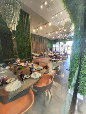 a dining room with a long table and chairs at 3053 Magic Village 3 suites jacuzzi BBQ 6min Disney in Orlando