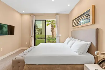 a bedroom with a large white bed and a window at 7562 Magic Village nice 8guests 4suites 8 min Disney in Orlando