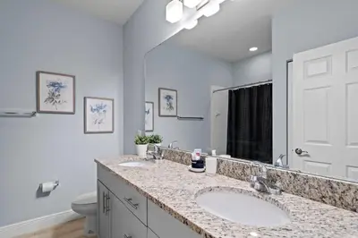 a bathroom with two sinks and a large mirror at 3212 WL 8 guests corner 192 near from Disney in Kissimmee