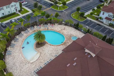 an overhead view of a swimming pool with chairs and palm trees at 3212 WL 8 guests corner 192 near from Disney in Kissimmee