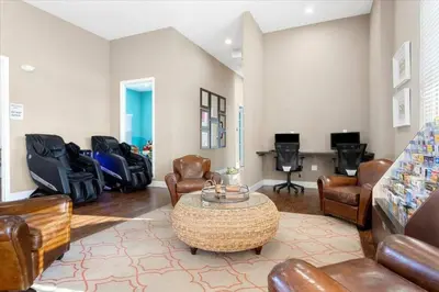 a living room with leather chairs and a table at 3212 WL 8 guests corner 192 near from Disney in Kissimmee