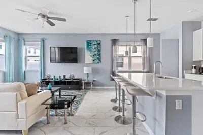 a kitchen and living room with a couch and a table at 5129 Tasty renovated 8 guests BBQ near Disney in Kissimmee