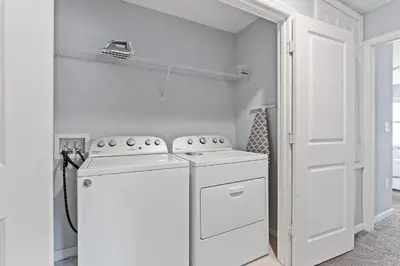 a white kitchen with a stove and a white door at 5129 Tasty renovated 8 guests BBQ near Disney in Kissimmee