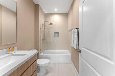 a bathroom with a toilet and a tub and a sink at 7462 Magic Village 8guests 4suites near Disney and 192 in Orlando