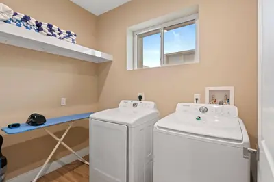 a laundry room with a washer and dryer and a window at 7462 Magic Village 8guests 4suites near Disney and 192 in Orlando