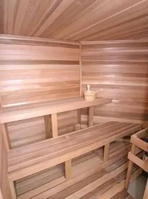 a wooden sauna with a wooden bench in it at Eva Kingdom back to forest home close to disney in Kissimmee