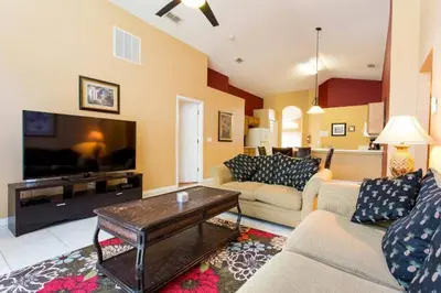 a living room with two couches and a flat screen tv at Eva Kingdom back to forest home close to disney in Kissimmee