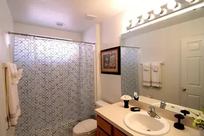 a bathroom with a shower with a sink and a toilet at Eva Kingdom back to forest home close to disney in Kissimmee