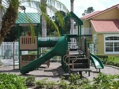 a playground with a slide in front of a house at Eva Kingdom back to forest home close to disney in Kissimmee