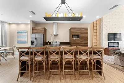 a kitchen and dining room with a table and chairs at 7478 Magic Village 8guests 4suites 8min Disney in Orlando
