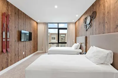 a hotel room with two beds and a tv at 7478 Magic Village 8guests 4suites 8min Disney in Orlando