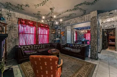 a living room with leather furniture and red curtains at Stay at Hogwarts Harry Potter's Home, Free Parking, Pets Allowed in Kissimmee