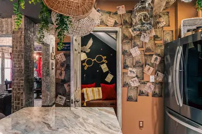 a kitchen with a wall covered in magnets and a refrigerator at Stay at Hogwarts Harry Potter's Home, Free Parking, Pets Allowed in Kissimmee