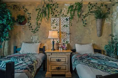 a bedroom with two beds and a table with a lamp at Stay at Hogwarts Harry Potter's Home, Free Parking, Pets Allowed in Kissimmee