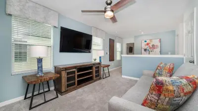 a living room with a couch and a flat screen tv at 8972 Amelia Downs in Orlando
