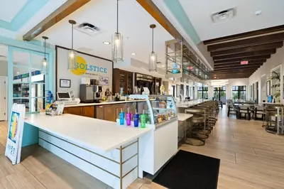 a restaurant with a counter and tables and chairs at 8972 Amelia Downs in Orlando
