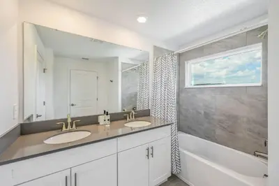 a bathroom with two sinks and a window at Families Deluxe Dream Vacation 10 min from Disney in Kissimmee