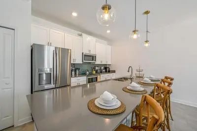 a kitchen with a table with chairs and a refrigerator at Families Deluxe Dream Vacation 10 min from Disney in Kissimmee