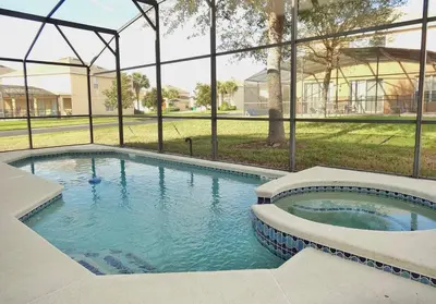 a swimming pool in a house with a large window at Edwin Island - Luxury home, Excellent location, Gated-Community in Kissimmee