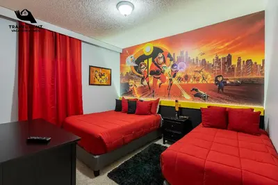 a bedroom with two beds and a painting on the wall at Themed Home Near Disney World in Kissimmee