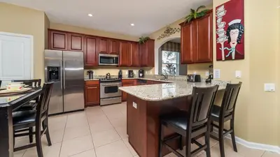 a kitchen with wooden cabinets and stainless steel appliances at 2501 Archfeld in Kissimmee