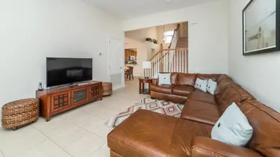 a living room with a couch and a flat screen tv at 2566 Archfeld in Kissimmee