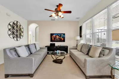 a living room with two couches and a ceiling fan at 2574 Archfeld in Kissimmee