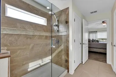 a bathroom with a shower with a glass door at 2574 Archfeld in Kissimmee