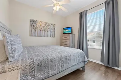 a bedroom with a bed and a ceiling fan at 2774 Almaton #403 in Kissimmee