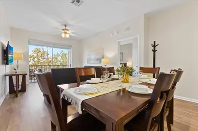 a dining room with a wooden table and chairs at 2774 Almaton #403 in Kissimmee