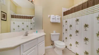 a bathroom with a toilet and a sink and a mirror at 2781 Almaton #103 in Kissimmee
