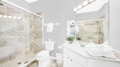 a bathroom with a shower and a toilet and a sink at 2788 Almaton #301 in Kissimmee