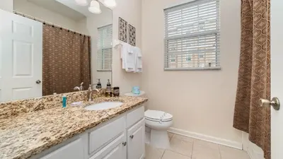 a bathroom with a sink and a toilet at 2809 Almaton #101 in Kissimmee