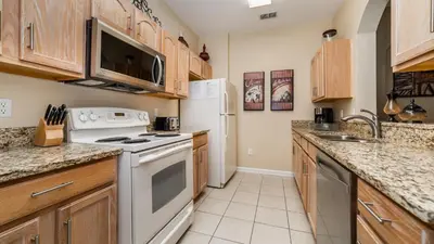 a kitchen with white appliances and wooden cabinets at 2809 Almaton #101 in Kissimmee