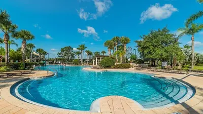 a swimming pool at a resort with palm trees at 2813 Almaton #403 in Kissimmee