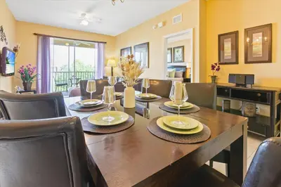a dining room with a wooden table and chairs at 2813 Almaton #403 in Kissimmee