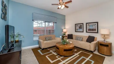 a living room with a couch and a tv at 3031 Beach Palm in Kissimmee