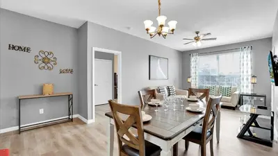 a dining room and living room with a table and chairs at 2301 Butterfly Palm #301 in Kissimmee