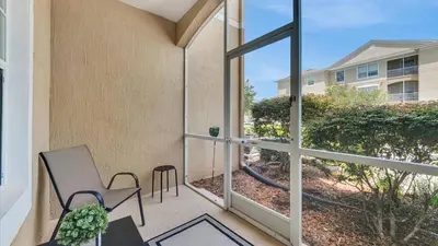 a balcony with a view of a building at 2303 Butterfly Palm #102 in Kissimmee