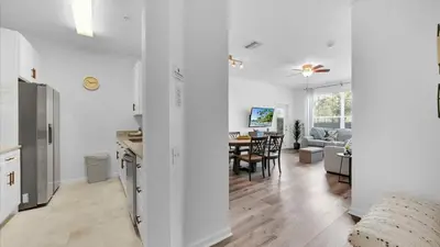 a living room with a kitchen and a dining room at 2303 Butterfly Palm #102 in Kissimmee