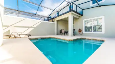 a swimming pool in a house with a glass ceiling at 4805 Brier Rose in Kissimmee
