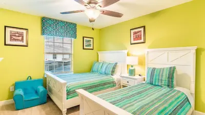 a bedroom with two beds and a ceiling fan at 4805 Brier Rose in Kissimmee