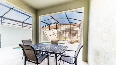 a patio with a table and chairs on a balcony at 4805 Brier Rose in Kissimmee